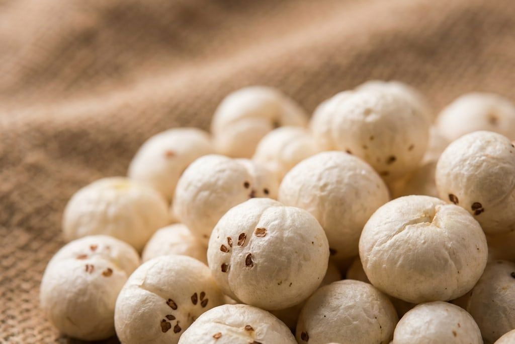 Close-up of plain popped makhana kernels on jute cloth